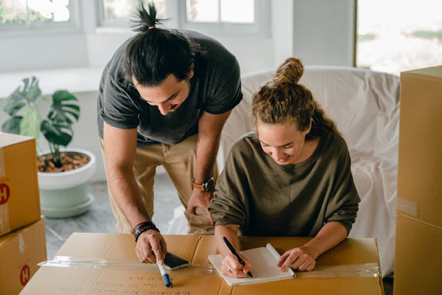 Couple packing and making an inventory before their move